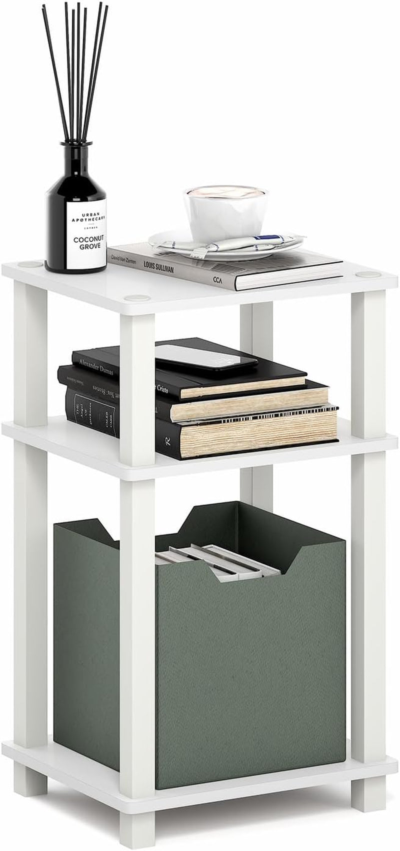 White three-tier side table with stacked books and a green storage box in the bottom shelf