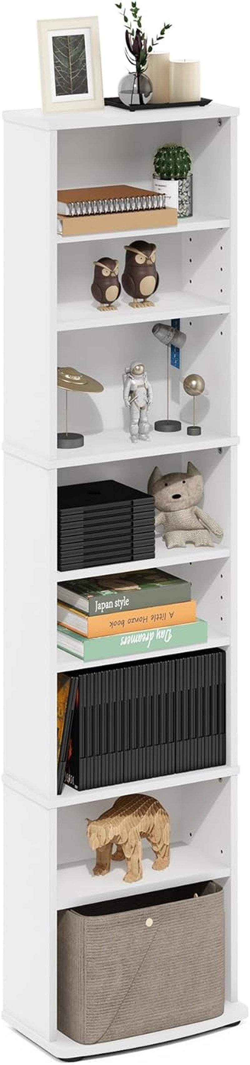 Full-height white tower staged with framed photo, toys, books and a fabric storage bin on lower shelf.