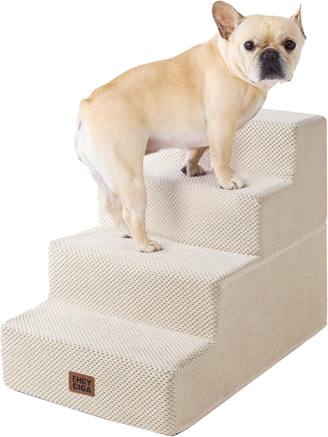 Small tan dog standing on cream-colored three-step pet stairs with textured cover