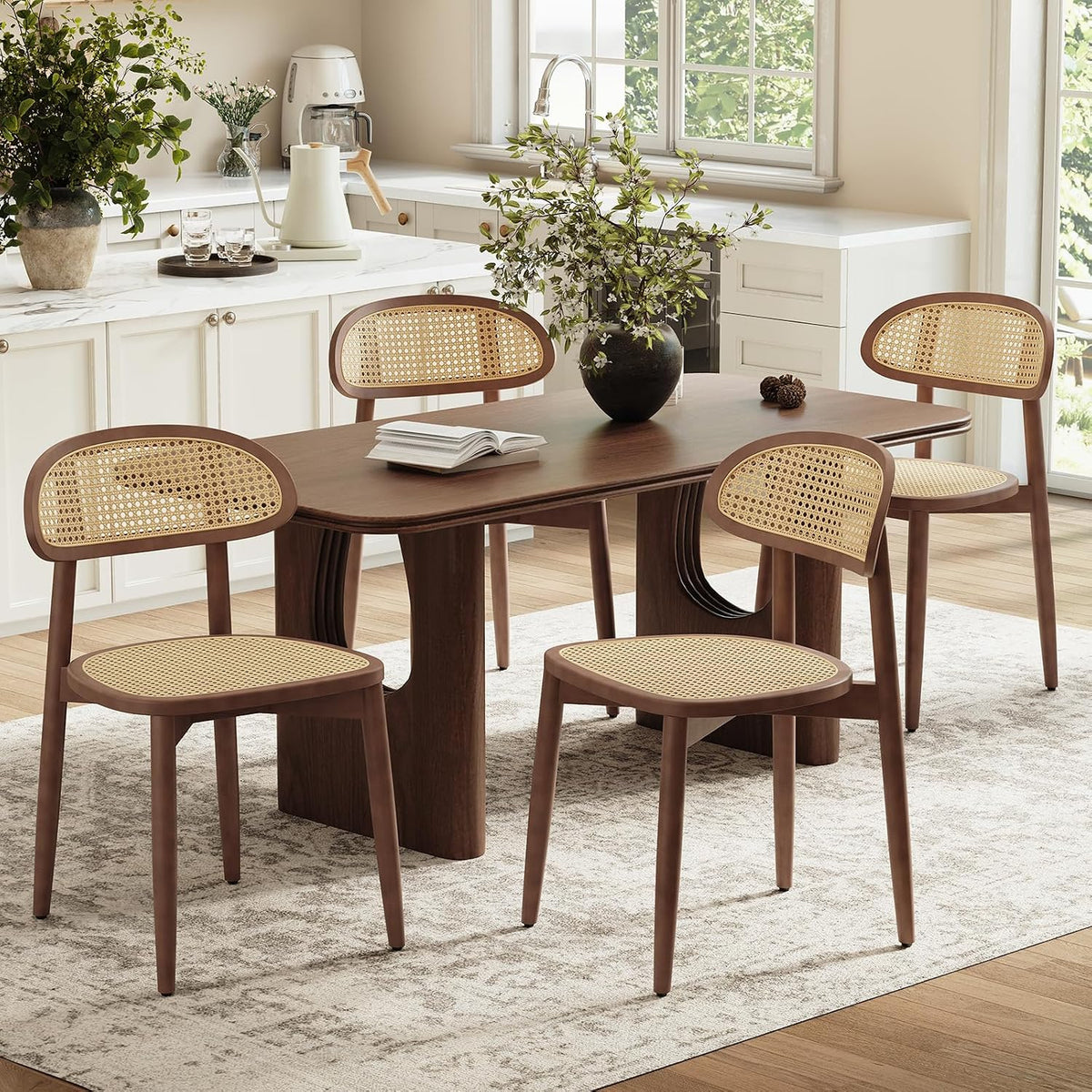 Set of four cane-back chairs arranged around a dark wood dining table in a bright kitchen-dining area