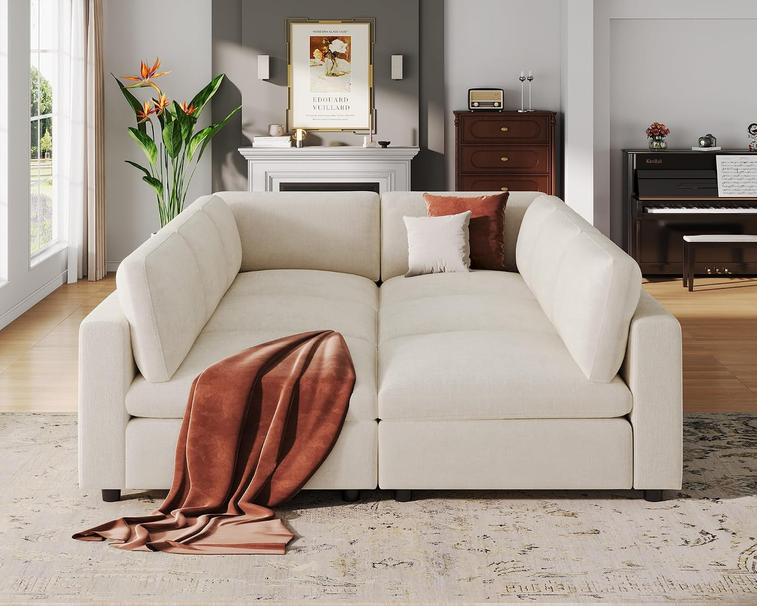Centered view into the corner of the sectional showing two facing chaise-style seats and a rust-colored throw draped over
