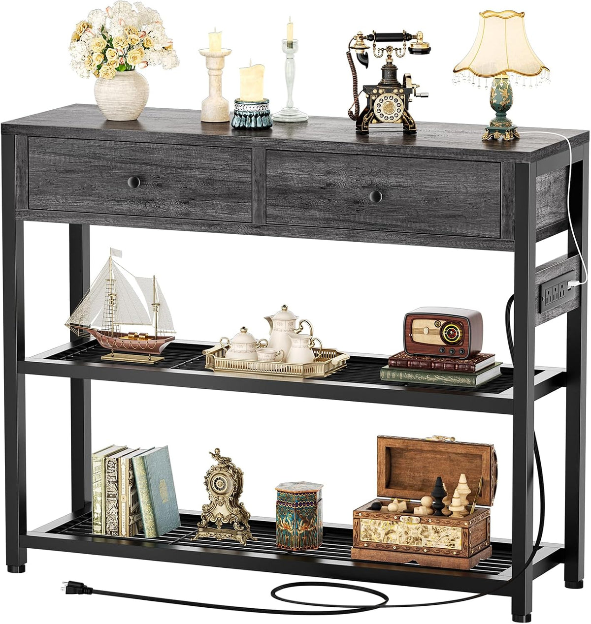 Console table in charcoal/black-wash wood finish with two drawers, slatted lower shelves and a side-mounted power outlet.