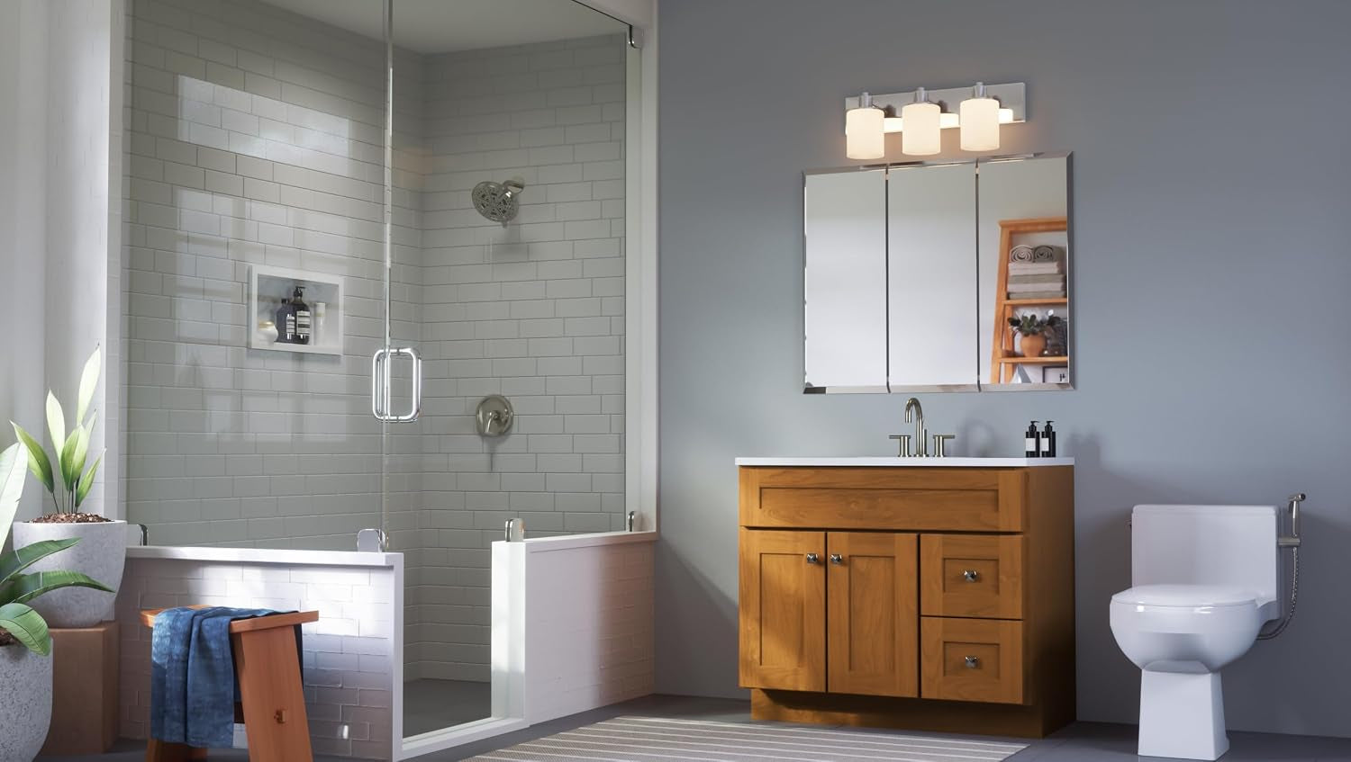 Installed three-door mirrored medicine cabinet above a wood vanity in a bright shower-adjacent bathroom