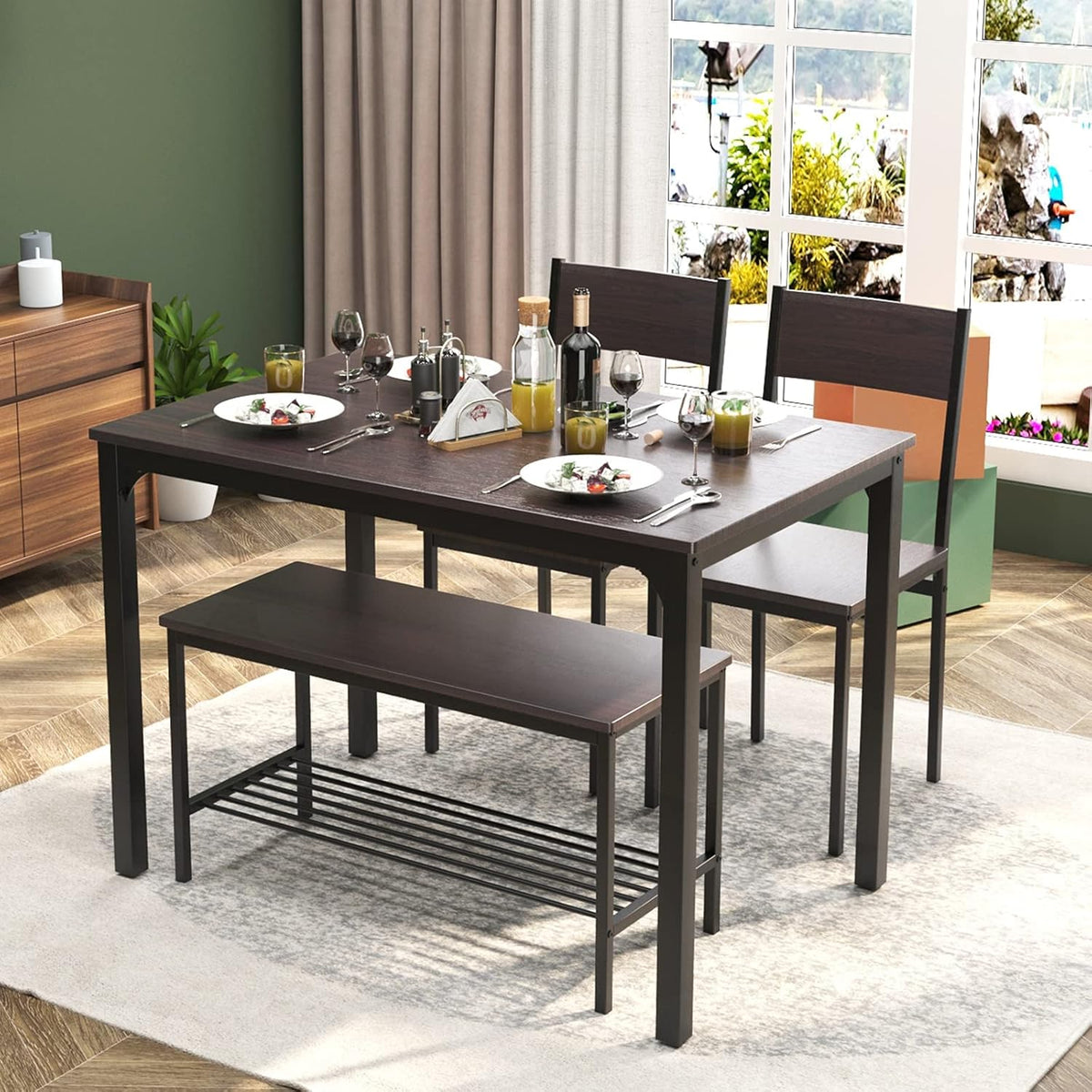 Dining table with two chairs and bench tucked under the table shown on a rug near a large window