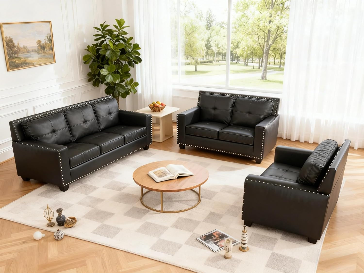 Angled overhead shot of the black three-piece set around a round wood table on a light checkered rug by a large window.