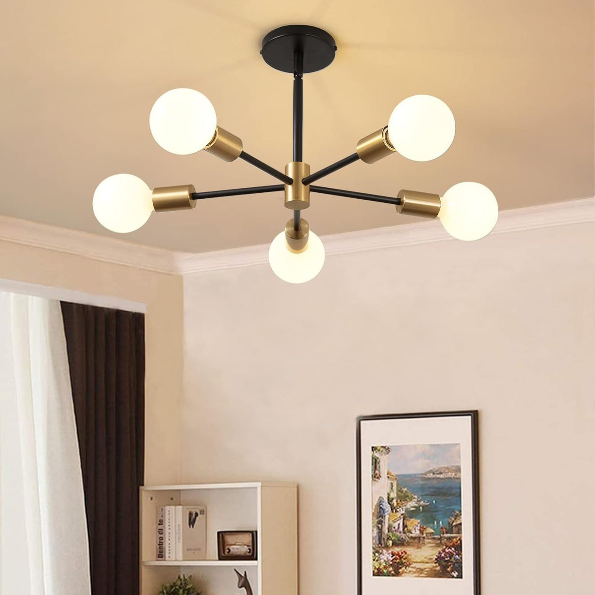 Gold and black six-arm chandelier mounted close to the ceiling in a light-colored room.