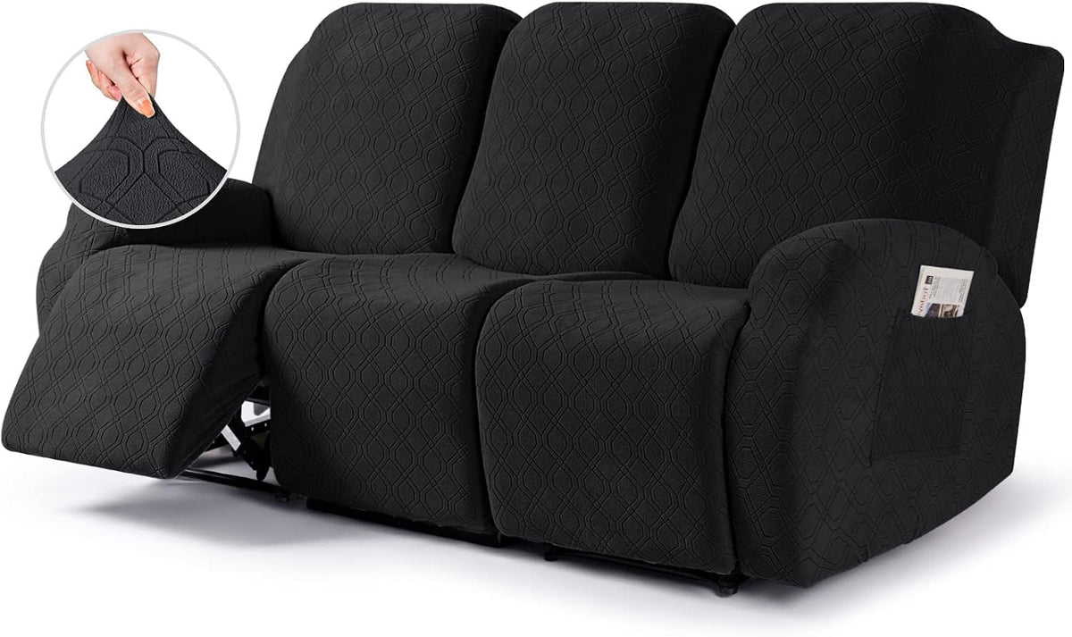 Low angled three-quarter view of a dark-gray three-seat recliner cover with left footrest down exposing the metal mechanism.