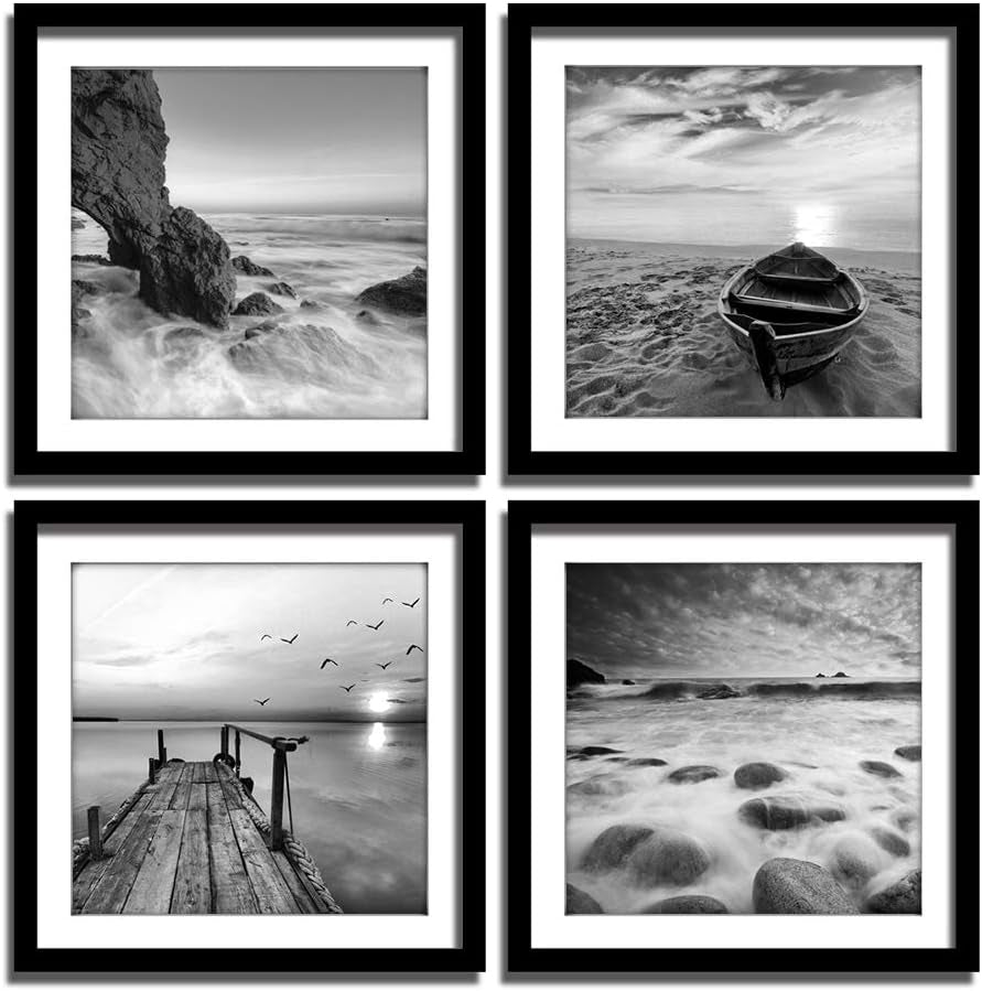 Four black-and-white seascape framed prints in black frames with white mats shown in a square 2x2 grid close-up view