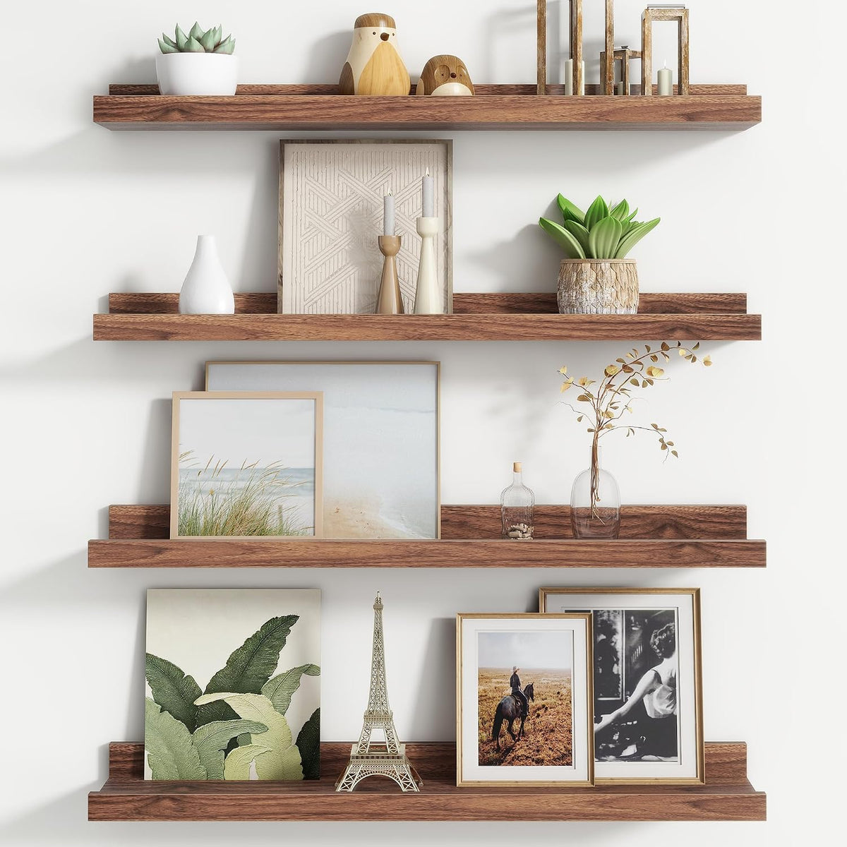 Three medium brown wood floating ledges styled with photos, a small Eiffel Tower and vases.