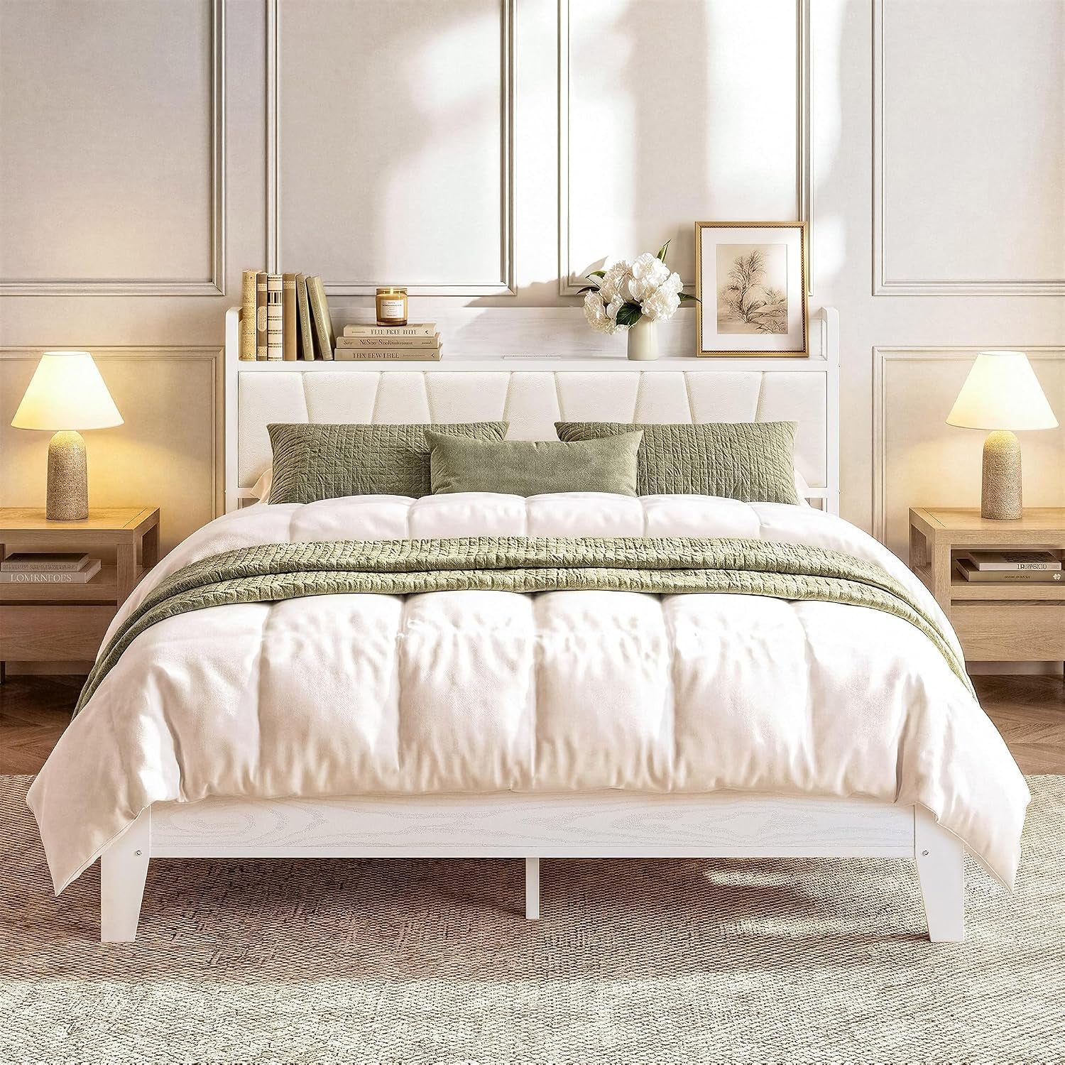 Front view of a white upholstered headboard bed in a styled bedroom with green pillows and wooden nightstands.