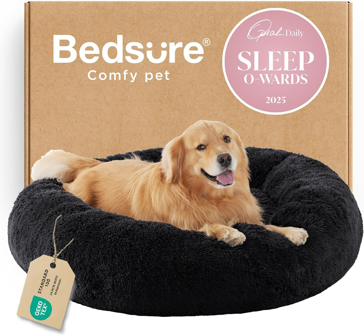 Black round faux-fur donut bed with a golden retriever resting inside and a cardboard box backdrop.