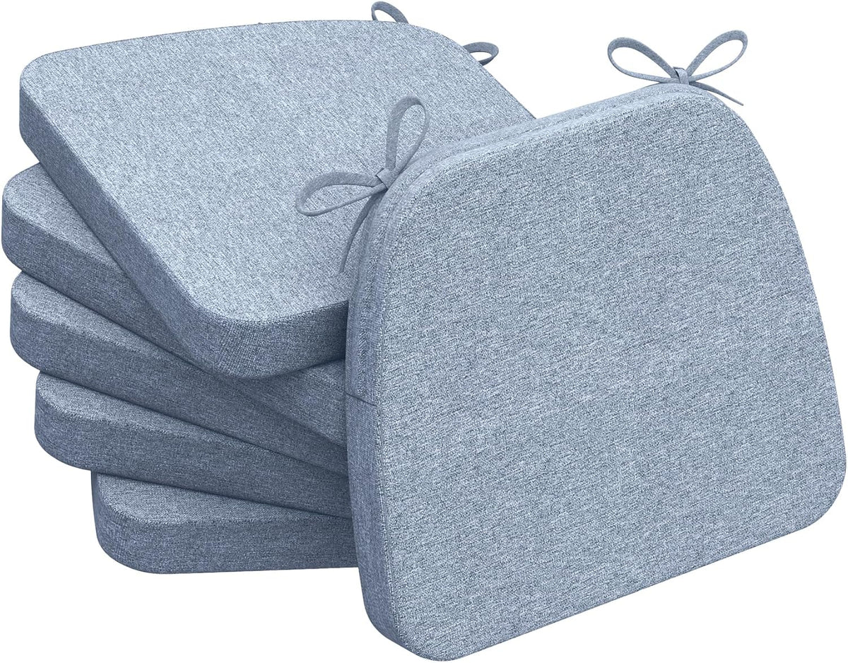 Stack of four light gray D-shaped chair cushions with visible tied loops and rounded front edge.