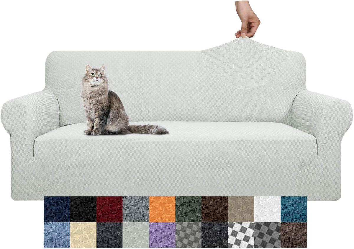 Three-cushion sofa covered in a light textured slipcover with a cat sitting on the seat.