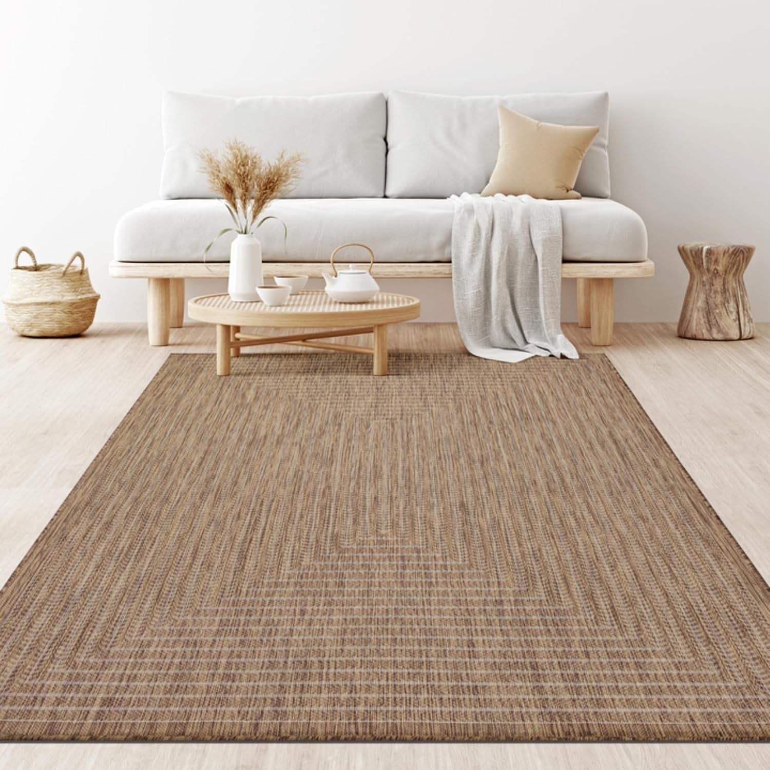 Living room scene with long tan woven rug under low wooden coffee table and sofa