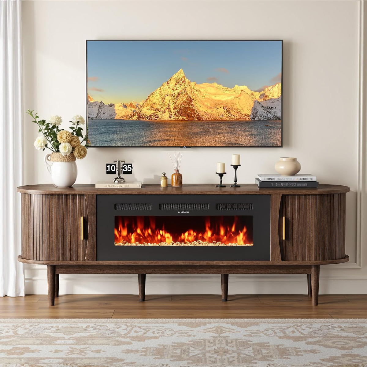 Straight front view of walnut TV stand displaying the 36" electric fireplace lit and tambour doors on both sides