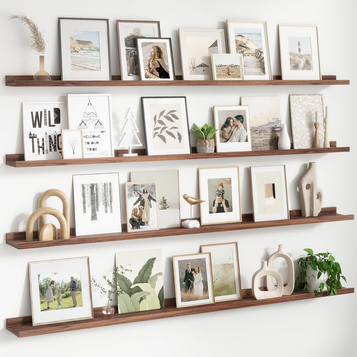 Four long dark wood floating ledges filled with assorted frames, sculptures and potted greenery.