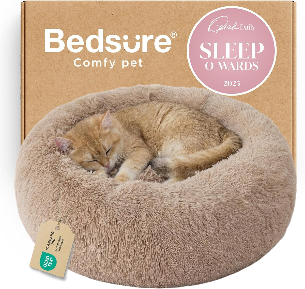 Beige faux-fur donut bed in front of cardboard packaging with a sleeping orange tabby cat