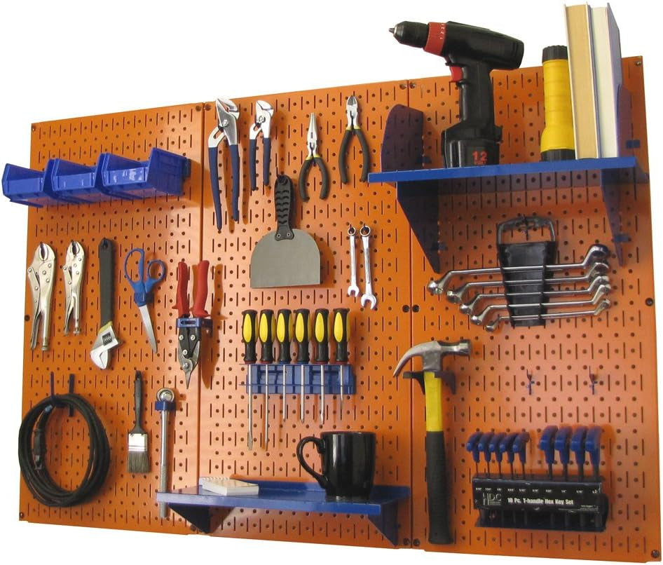Orange metal pegboard mounted with tools, hooks, blue shelves and small storage bins.