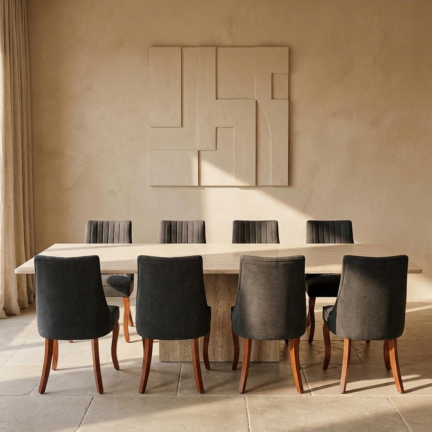 Rear view of six dark charcoal upholstered chairs with brown wood legs lined along a long stone table.