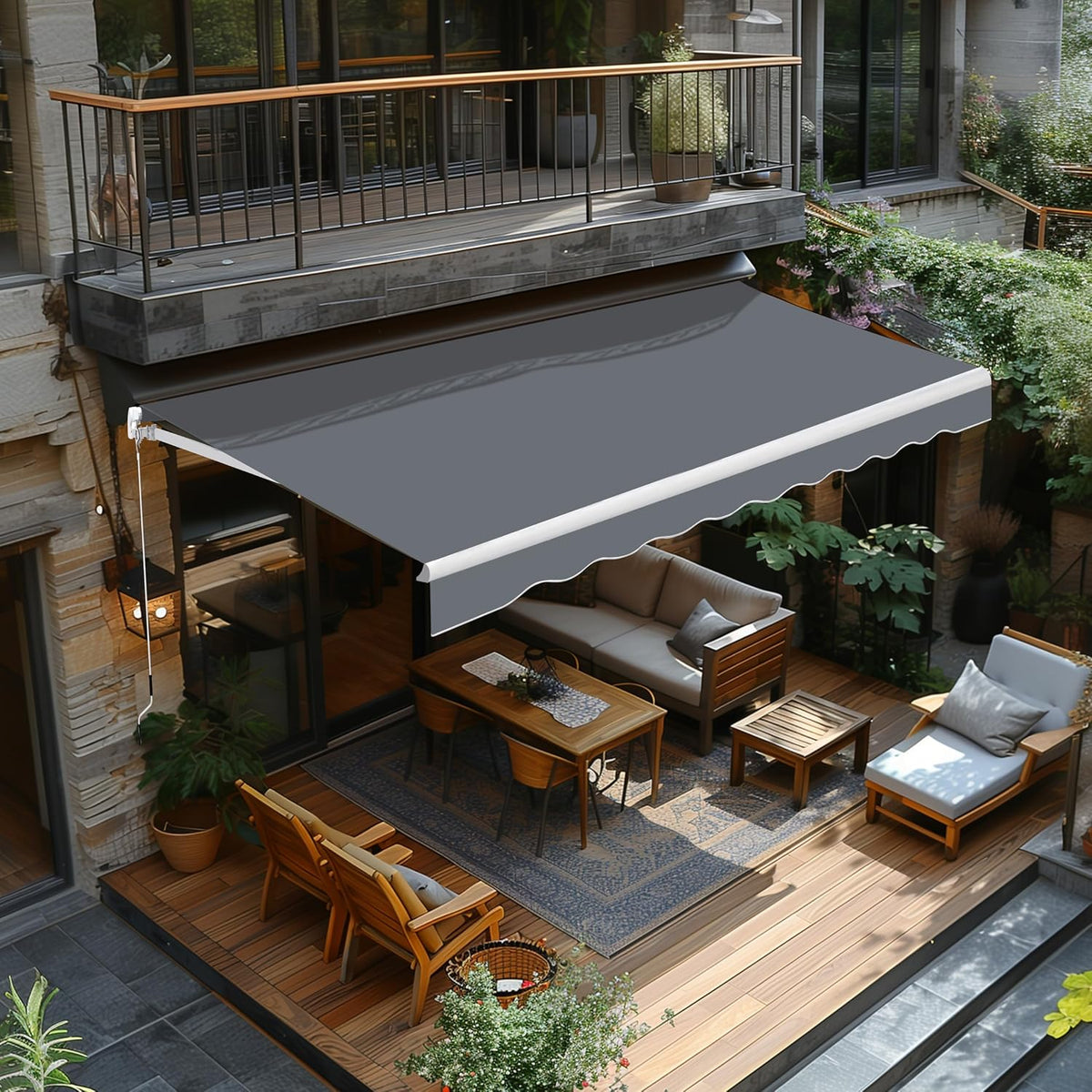 Installed dark gray retractable awning shading a furnished balcony and patio seating area.