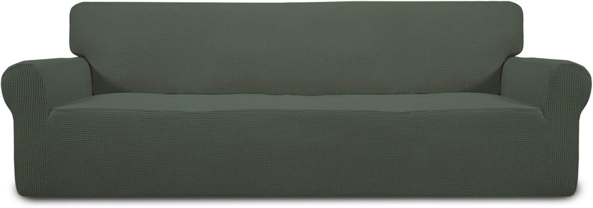 Full-width front view of a long sofa covered in a deep green stretch slipcover with rounded arms.