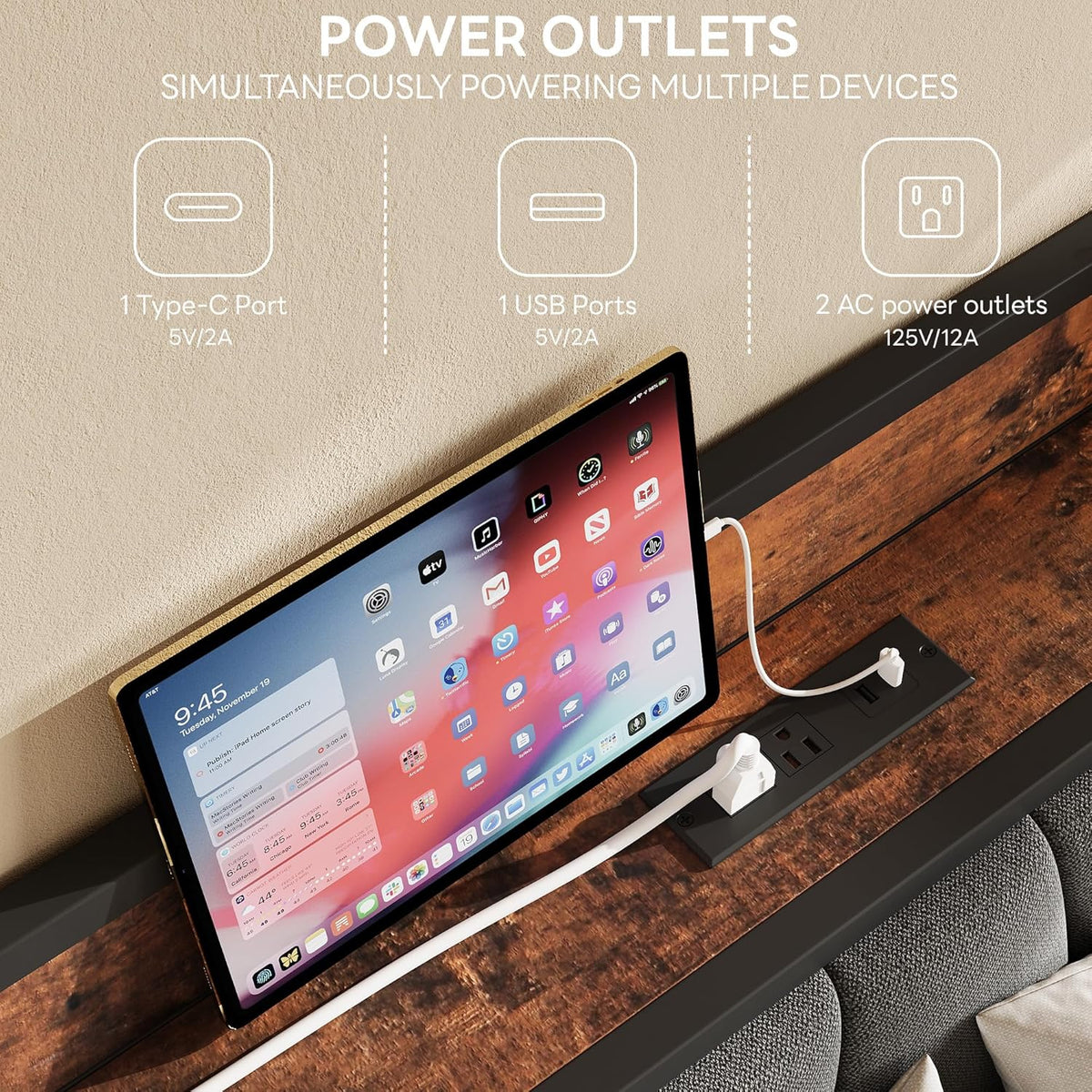 Top shelf of the headboard with a tablet propped up and a black power strip with plugged charging cables.
