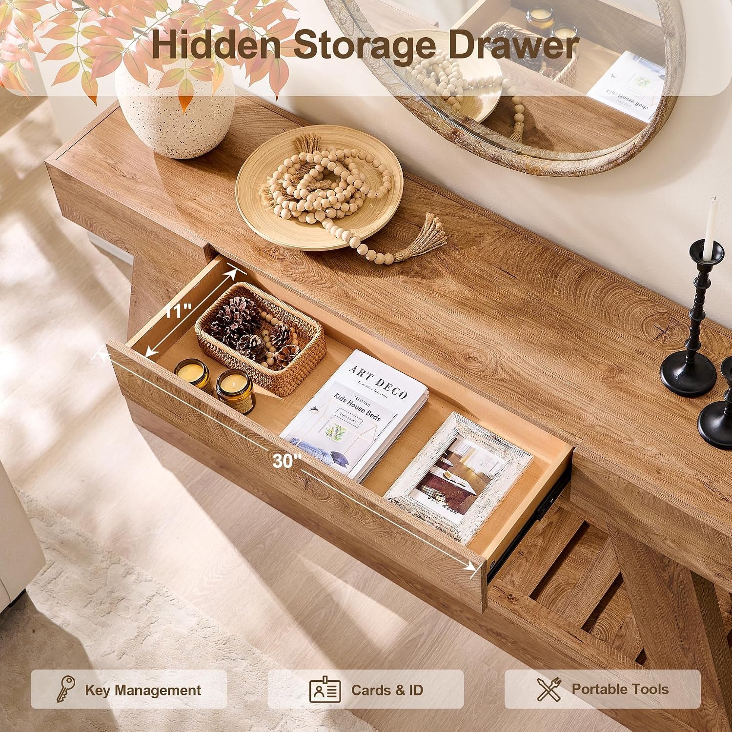 Open center drawer on the console table, shown holding candles, a basket, books, and a photo frame.