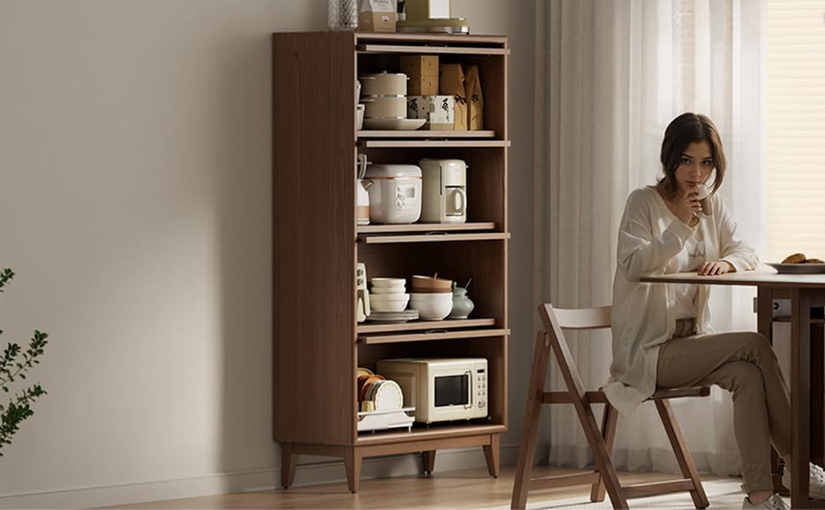 Brown wood bookcase styled in a dining area next to a table and folding chair