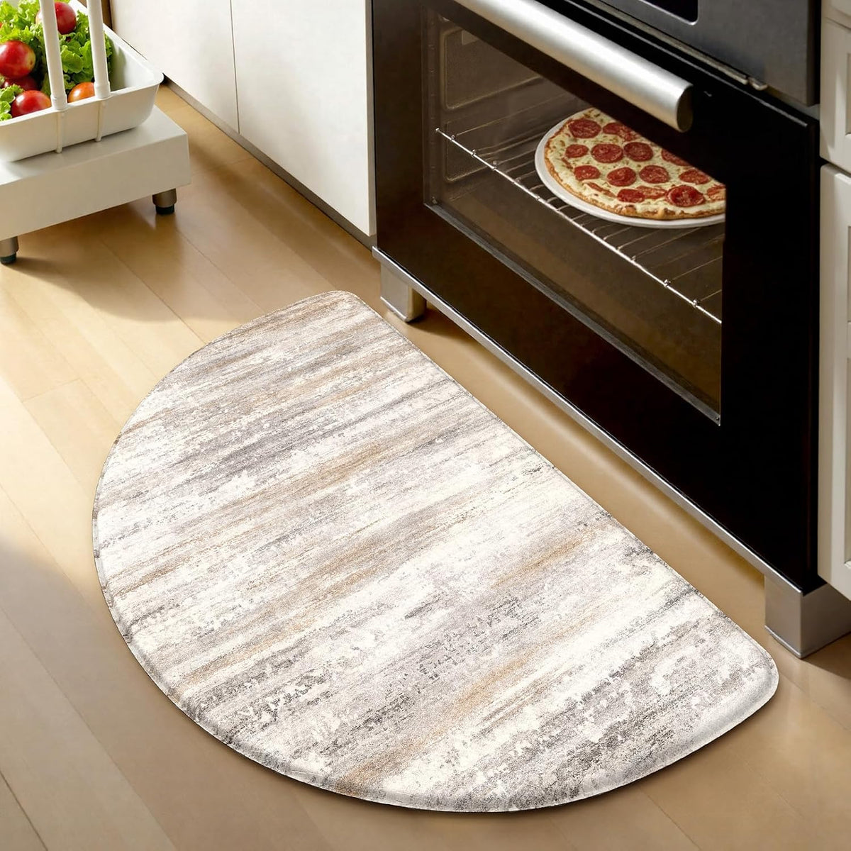 Half-round beige-toned anti-fatigue mat placed in front of a black oven, pizza visible inside oven.