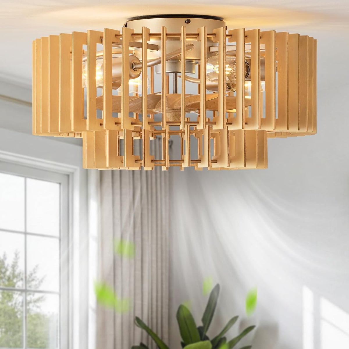 Beige/gold finish fan installed on a white ceiling with motion blur suggesting airflow near a window.