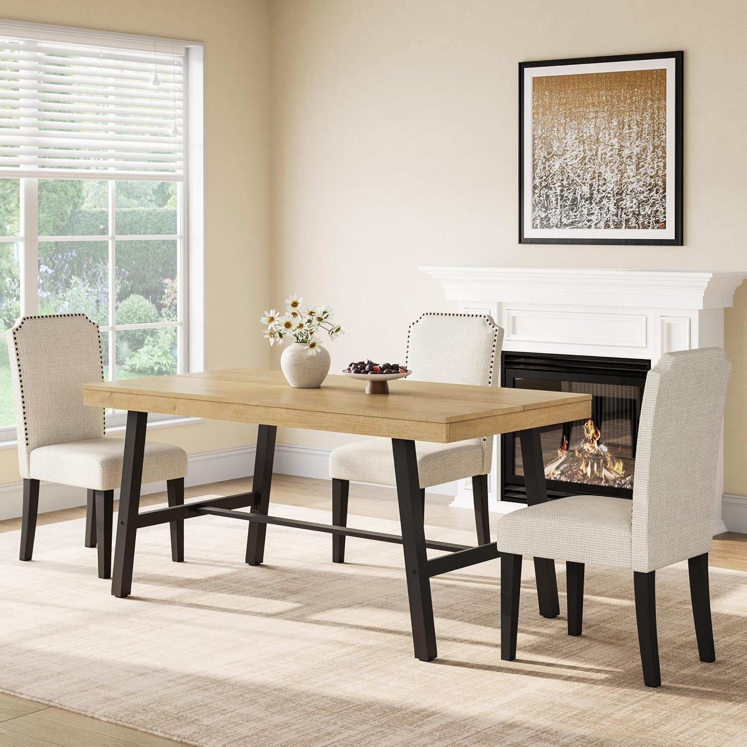 Rectangular light-wood table with black metal legs in a dining room by a fireplace and window