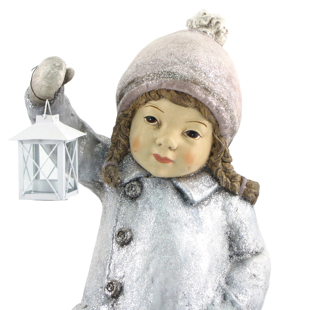 Blue-clad Christmas figure holding a lantern against a white background