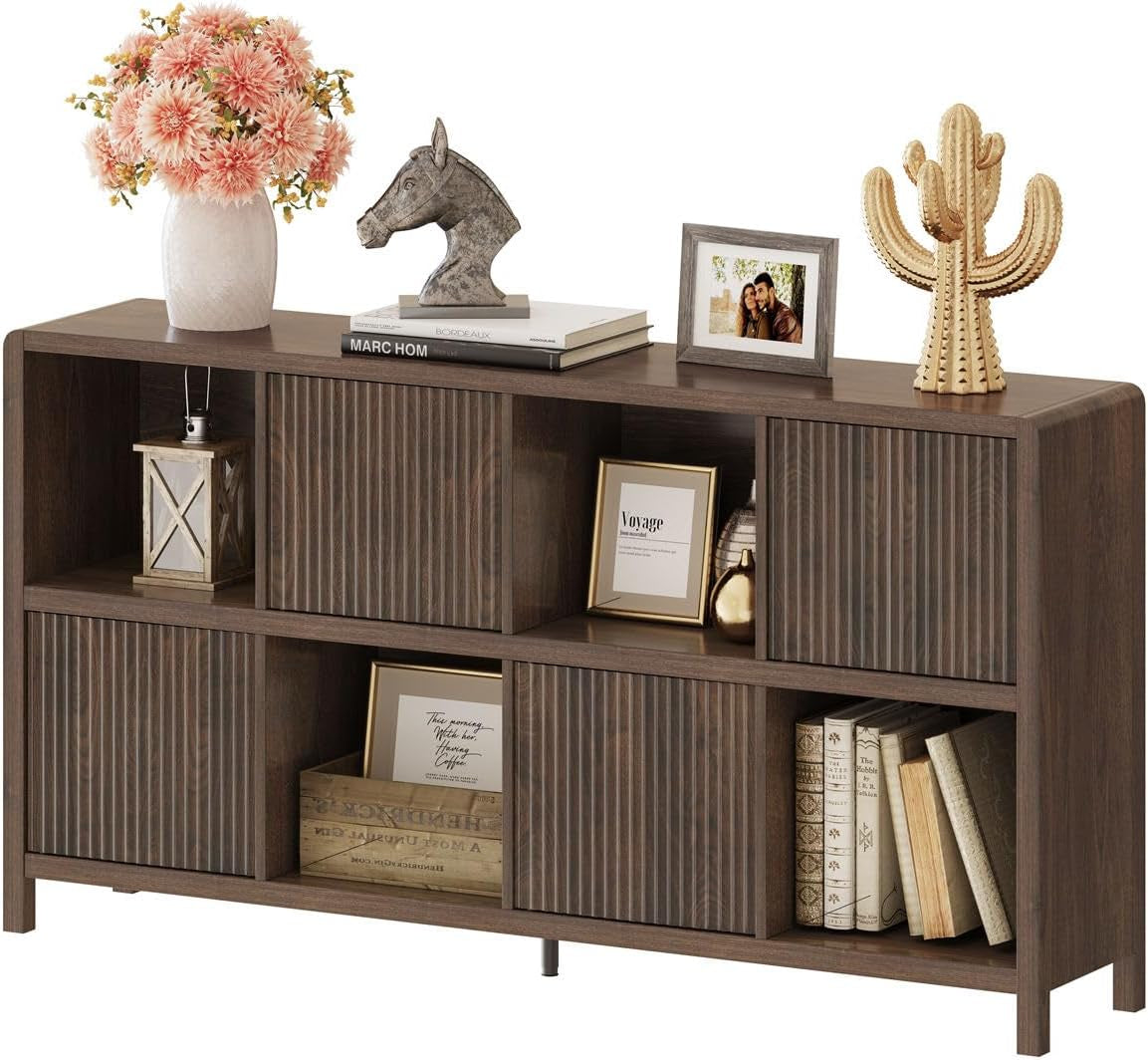 Dark brown bookcase close-up showing rounded corners, ribbed door panels and decorative objects on shelves