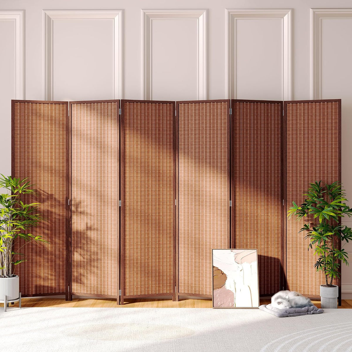 Dark brown four-panel bamboo screen set against paneled wall with plants and a cat sleeping nearby