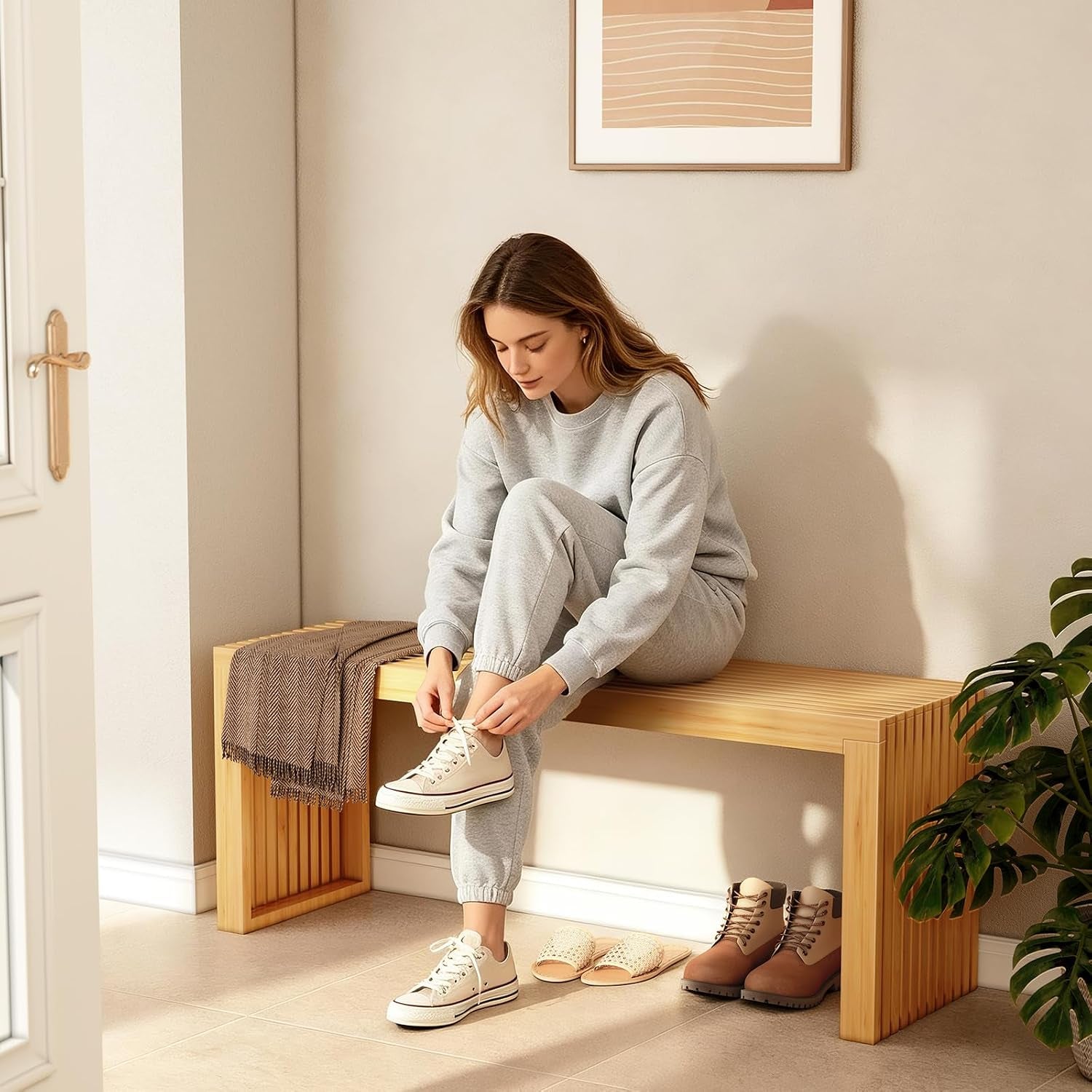 Person tying shoes while seated on a natural bamboo slatted bench in an entryway