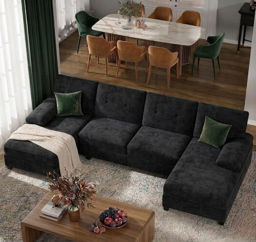 Black U-shaped 4-seat sectional with double chaise angled top-down view in a living room setting