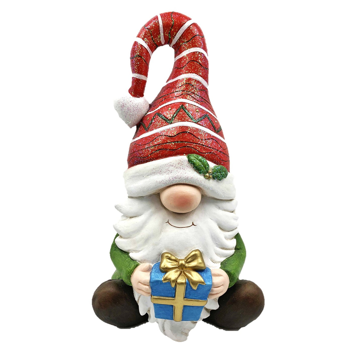 Sitting Christmas gnome with a tall red patterned hat, white beard, green outfit, and blue gift with a gold bow.