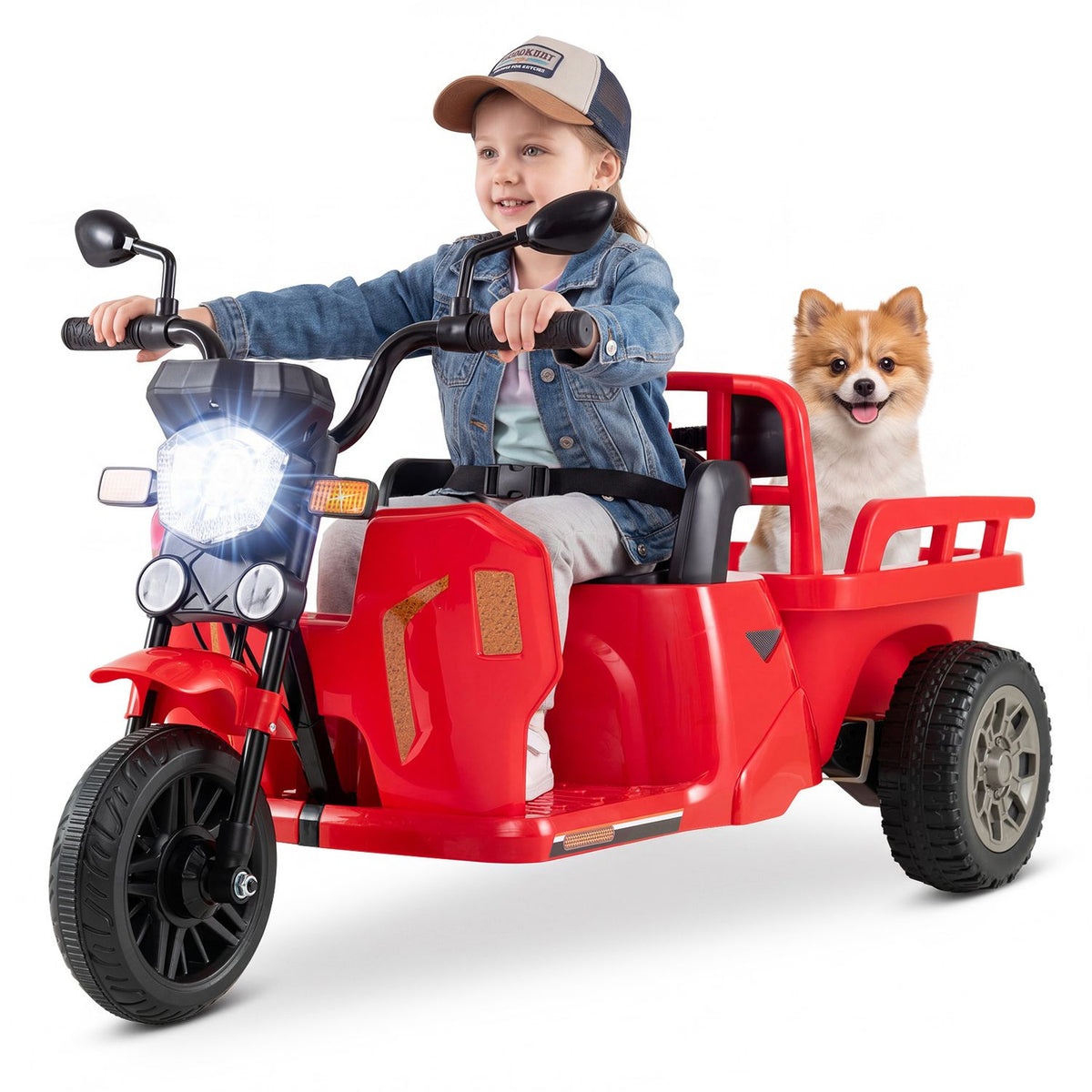 A child rides a red three-wheeled toy with a rear trailer beside a small dog against a white background.