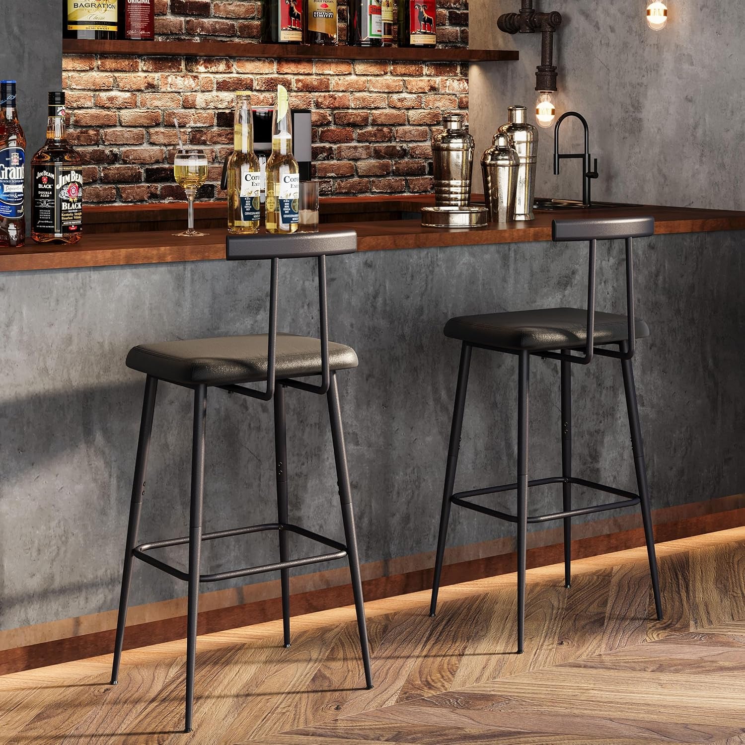 Two black counter stools placed at a wood bar with brick wall and industrial lighting in a dim bar scene