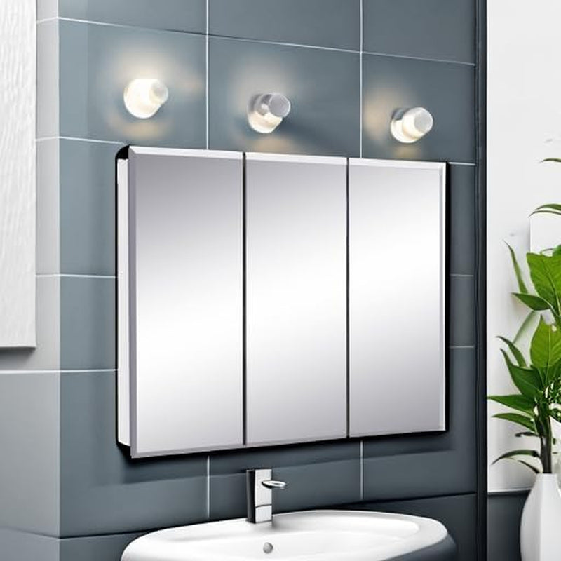 Three-panel mirrored cabinet installed above sink with vanity lights and tile backdrop.