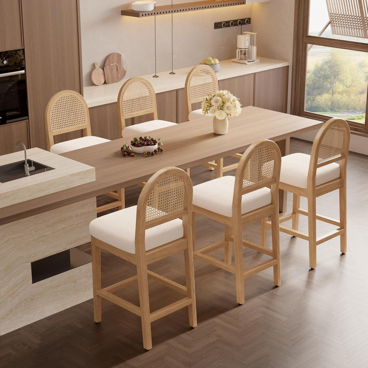 Six light-wood counter stools arranged around a dining table and island, showing woven backs and cream cushions.