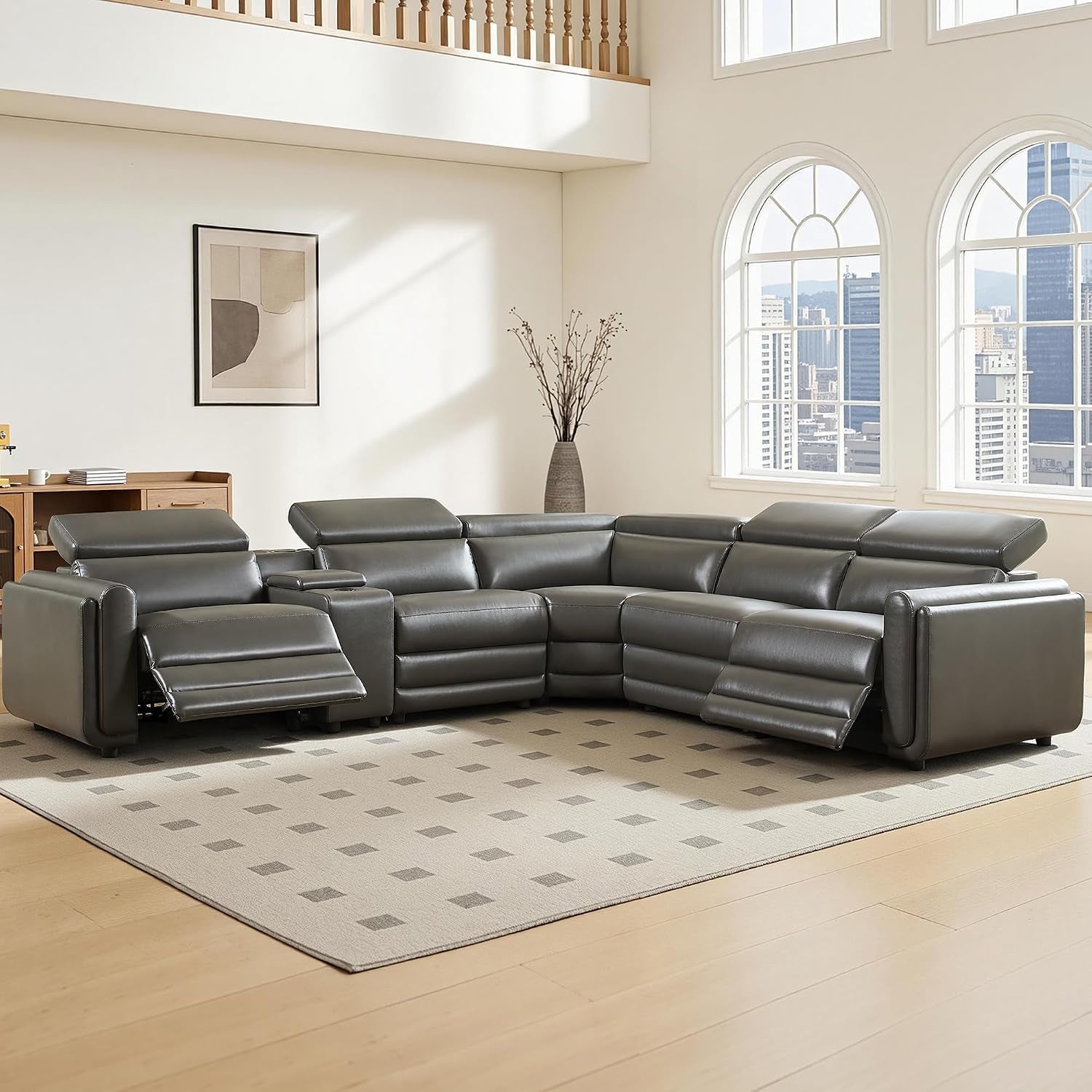 Dark gray leather power-reclining sectional shown with recliners extended on both ends in sunlit space