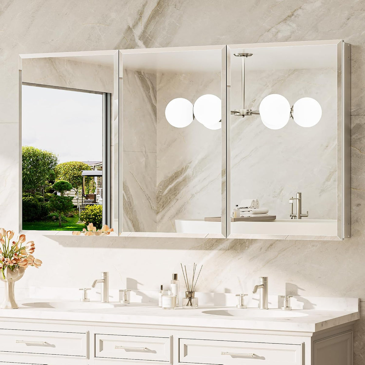 Three-door recessed mirrored medicine cabinet mounted above a double-sink vanity, reflecting a window and bathroom fixtures.