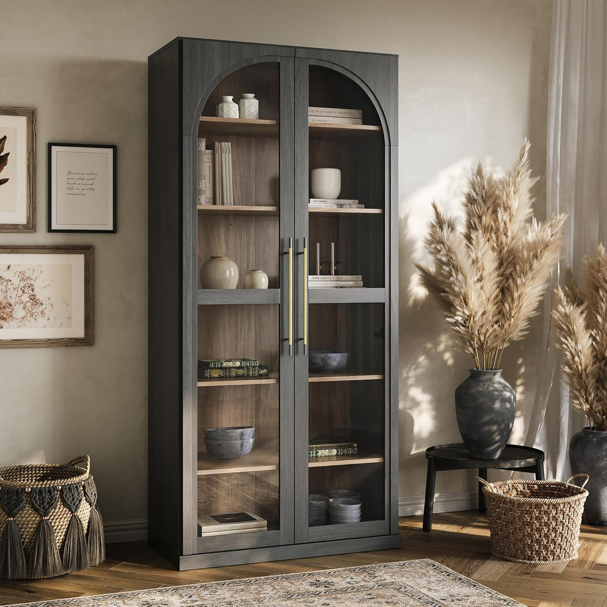 Same tall glass curio cabinet in a darker wood finish shown in the same room setting