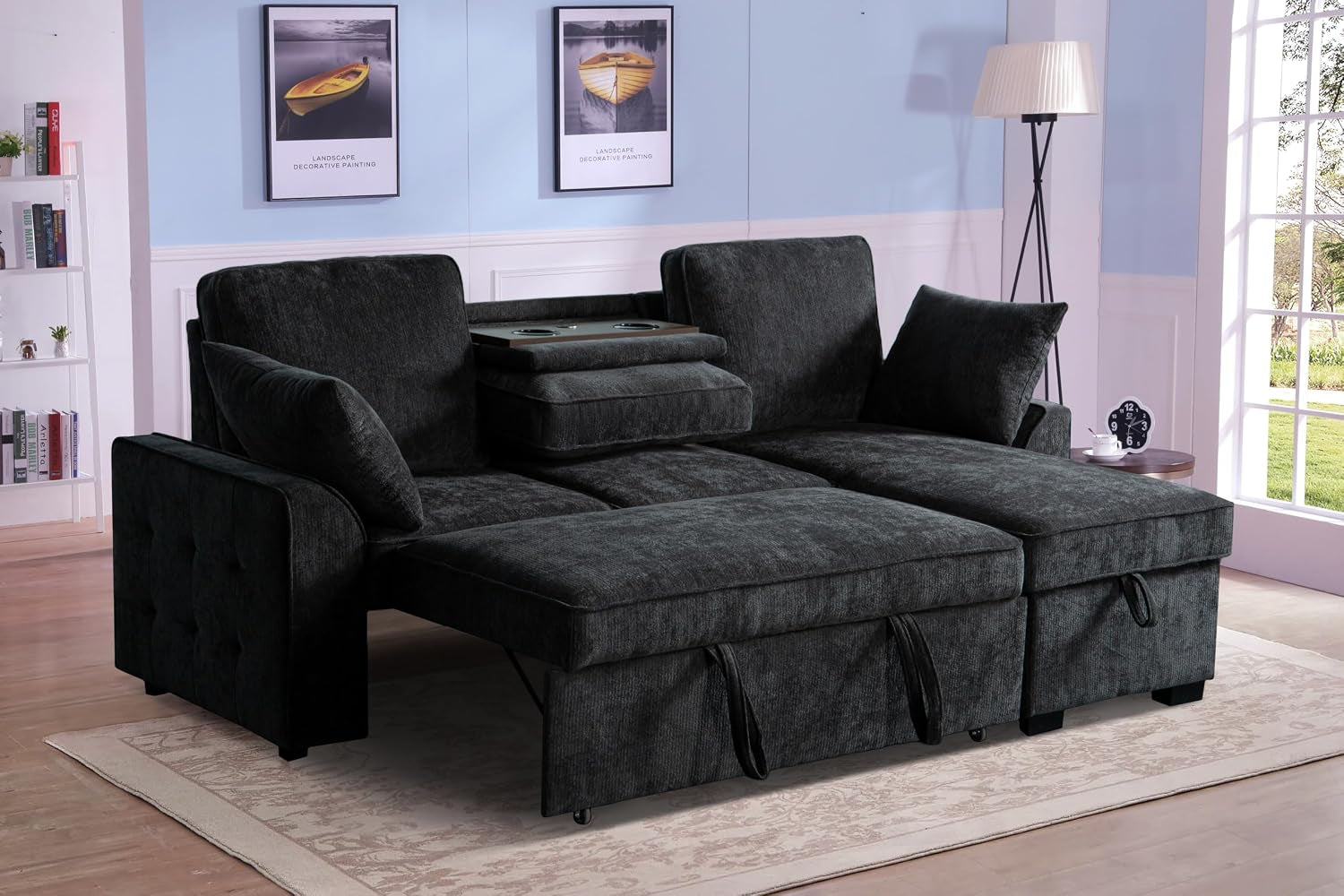Dark charcoal corduroy sectional sleeper with reversible storage chaise set up as a bed in a staged living room.