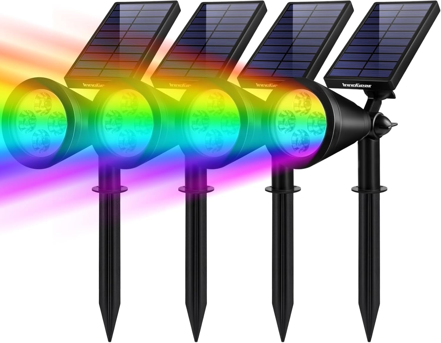 Four stake solar spotlights in a row projecting a multicolored beam to show color options