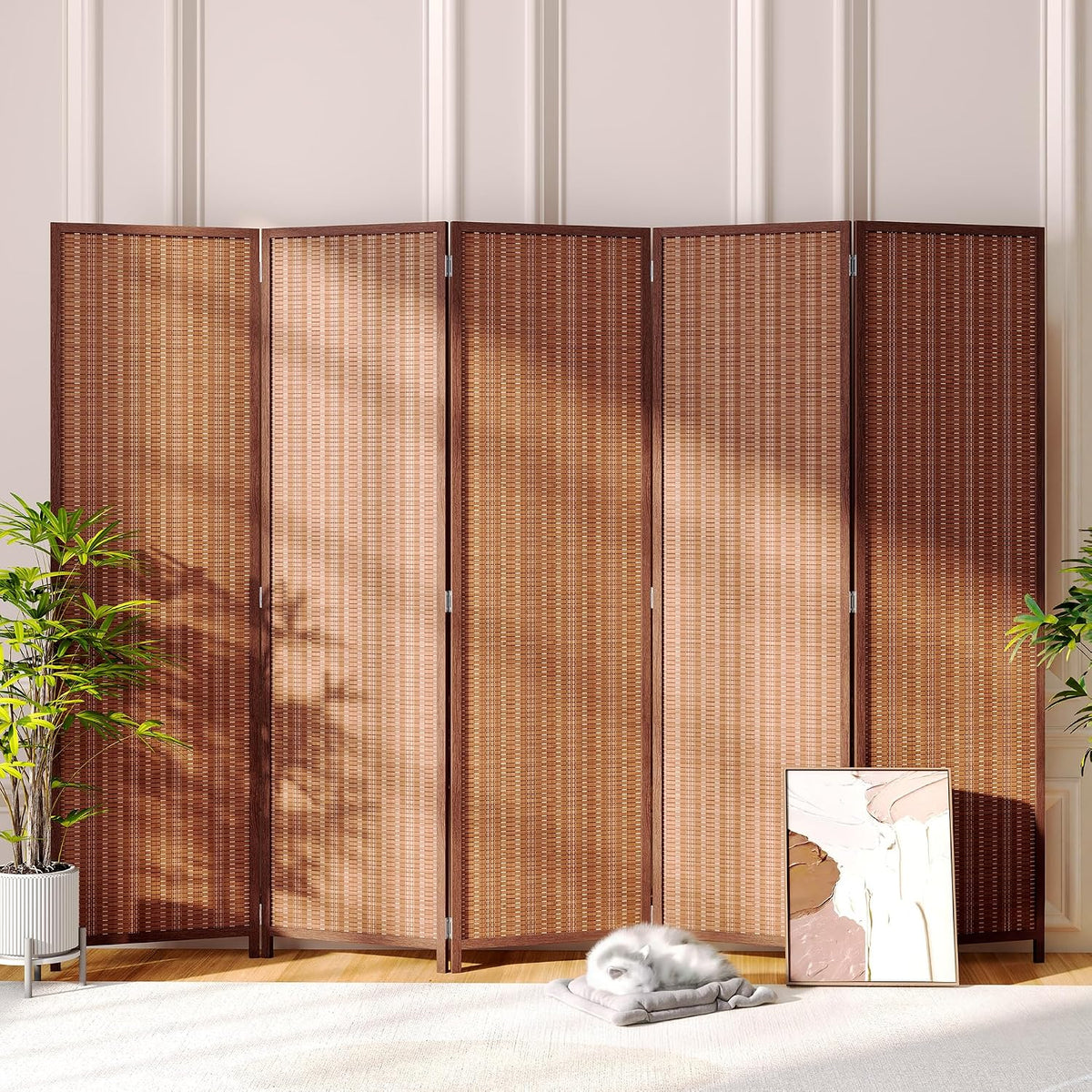 Dark brown bamboo room divider in a living setting with a framed print and a sleeping cat on a cushion
