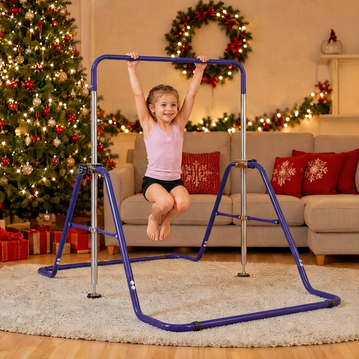 A child hangs from a purple practice bar in a living room decorated for the holidays.