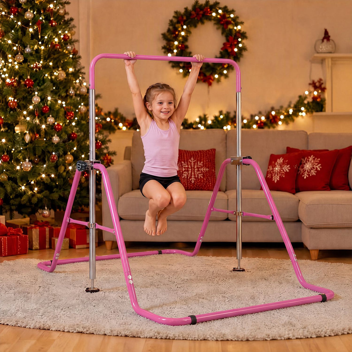 A child hangs from a pink gymnastics bar set up on a rug in a decorated living room.