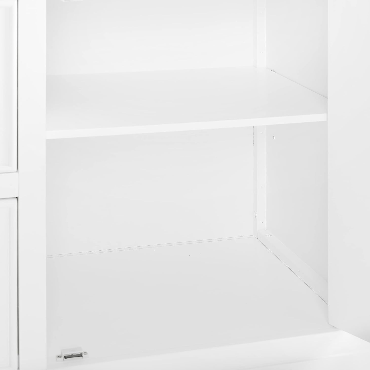 Close-up inside the cabinet showing a fixed middle shelf and empty lower compartment.